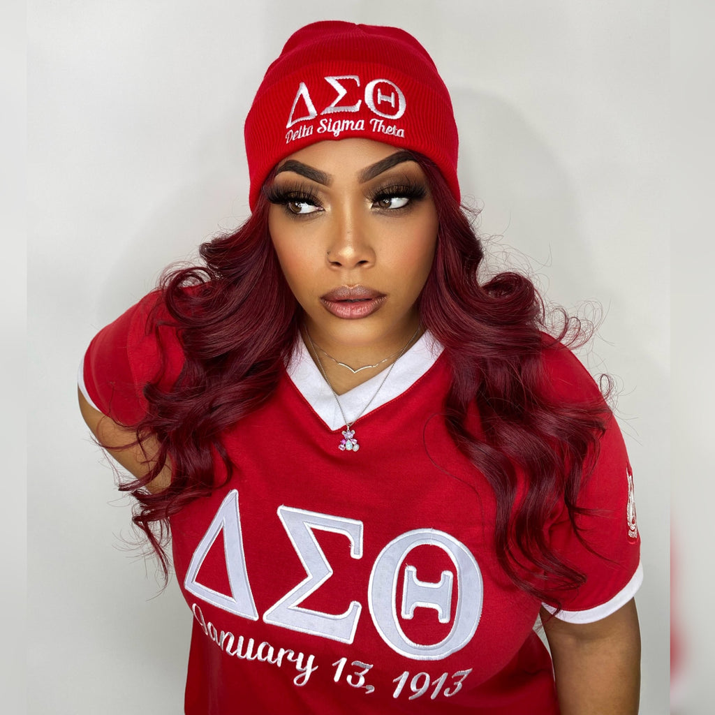 A woman in a red ΔΣΘ DST Embroidered Beanie Tshirt with the letters sigma (ΔΣΘ DST) embroidered on it.