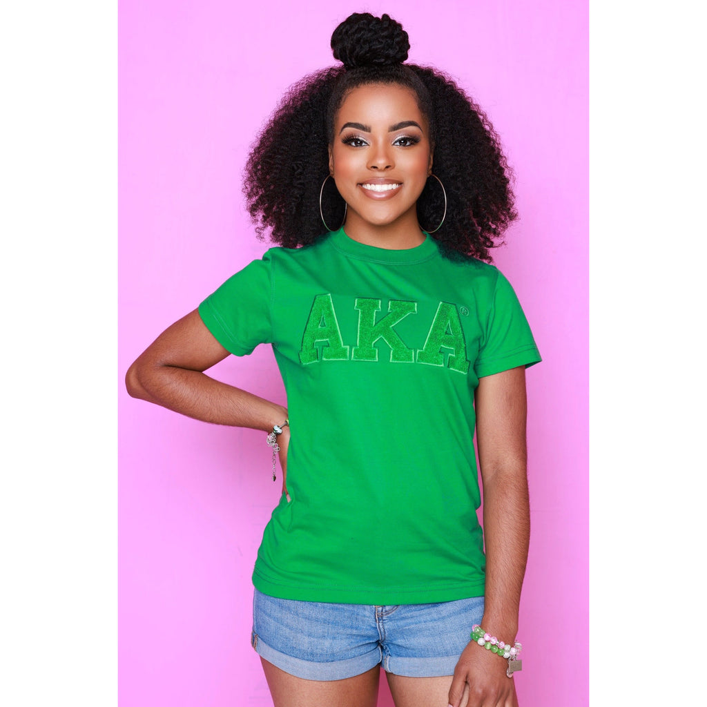 Soft premium green cotton Solid AKA Chenille Tee with embroidered logo. True to size; model wears XS, her usual fit.